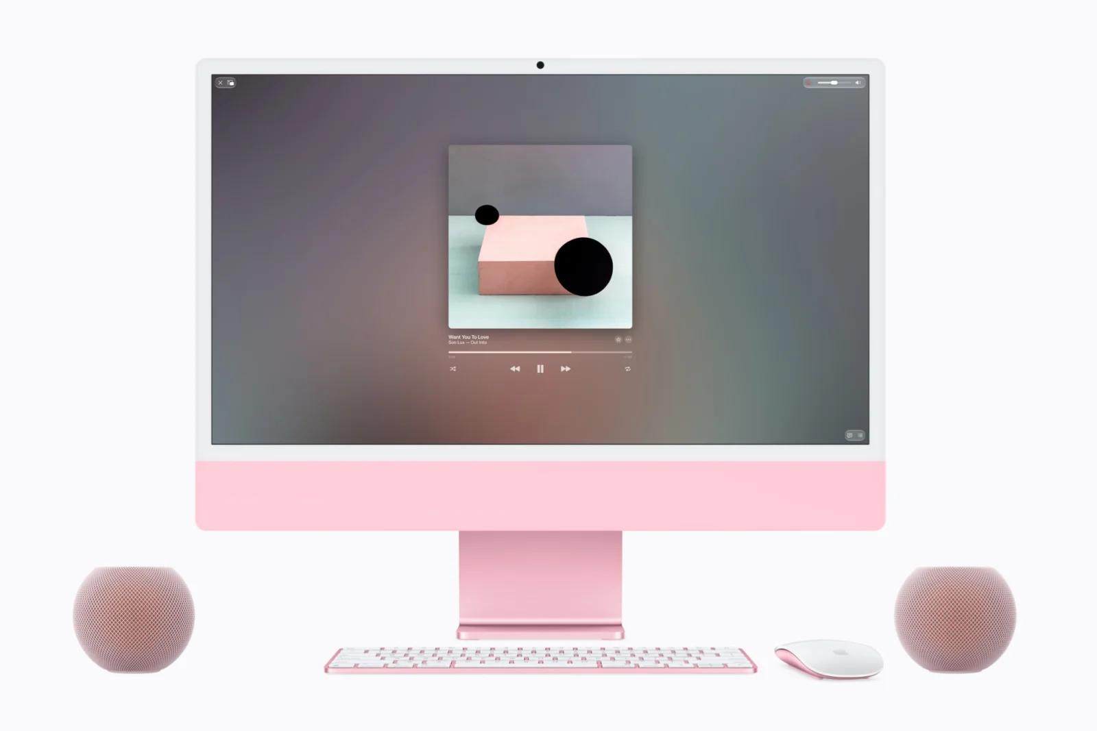 Dva HomePody mini 2 v růžové barvě vedle růžového iMacu